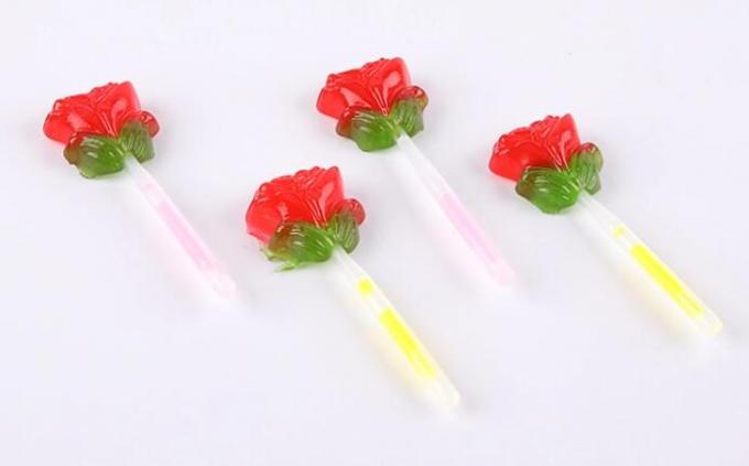 蛍光性は照明棒が付いているキャンデーのローズの花の形のロリポップをつけます